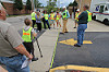 Walkability Expert Dan Burden Measures Parking Lot Entrances During a Walking Audit in Paw Paw Michigan